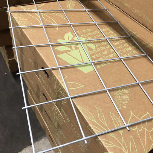 Stacked Varden plant boxes with green logos, "Let's grow together" text, beneath a metal wire grid. Sustainable packaging.