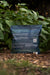 AZOMITE organic mineral fertilizer bag on mulch, improving plant health and soil nutrients for gardens.