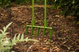 Robust green broadfork in a prepared garden bed. Ideal for deep soil aeration, digging, and organic gardening.