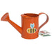 Orange kids watering can with a yellow and black bee design. Children's gardening tool.