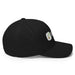Black baseball cap with embroidered green sprout and seed logo. White 'SEED' text partially visible. Eco-friendly headwear.