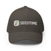 Dark brown baseball cap with embroidered Seedtime logo: a green seedling icon and white "SEEDTIME" text.