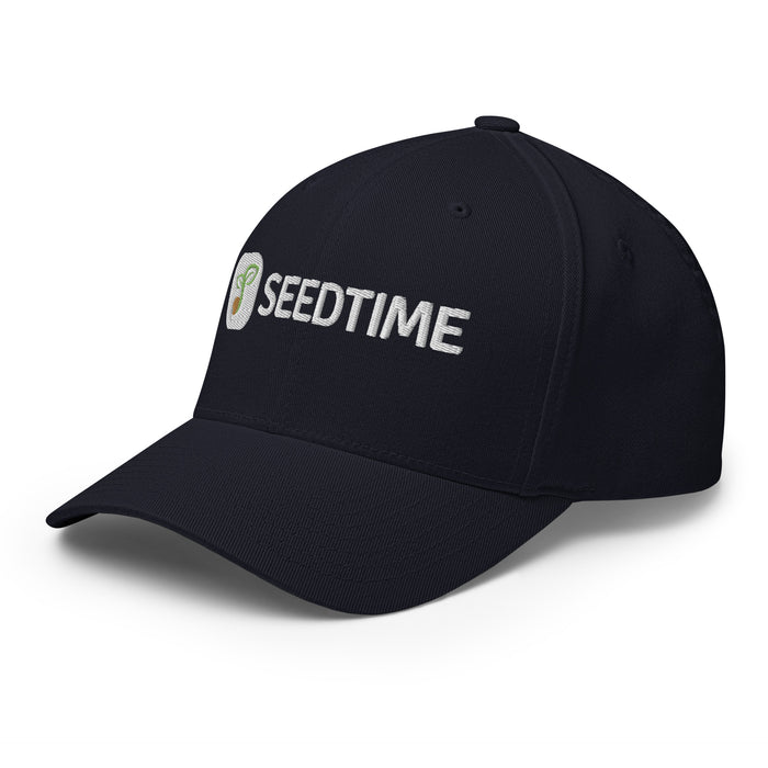 Navy blue baseball cap with white embroidered Seedtime logo and sprout graphic.