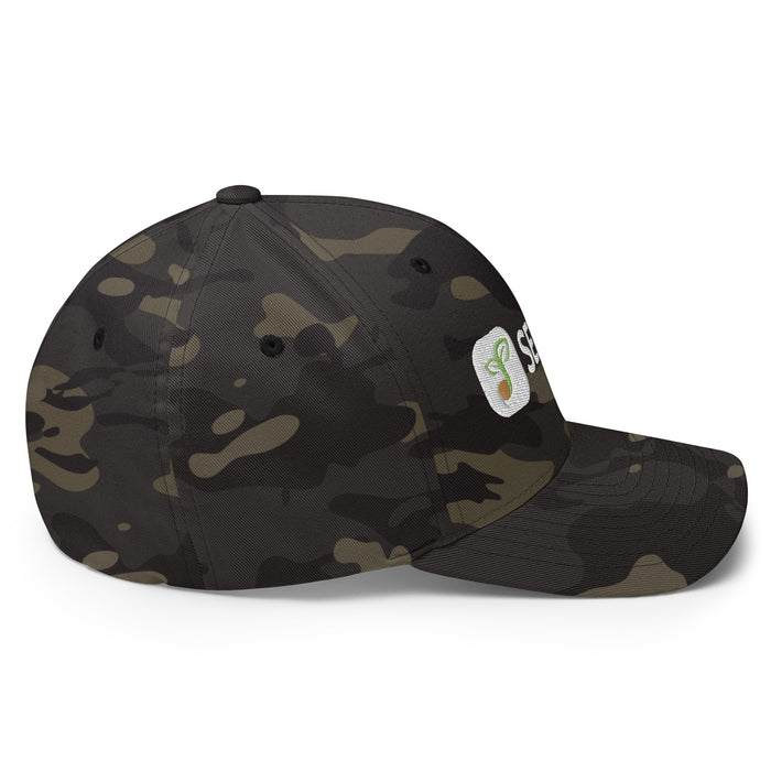 Dark camouflage baseball cap with white embroidered logo featuring a green sprouting seed. Stylish camo hat.