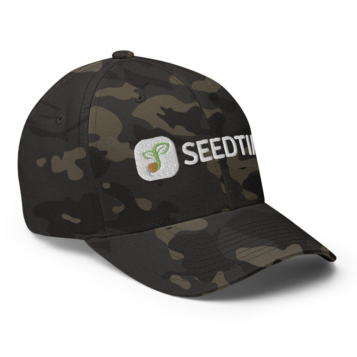 Dark camo dad hat with white Seedti sprout logo embroidery. Stylish camouflage baseball cap.