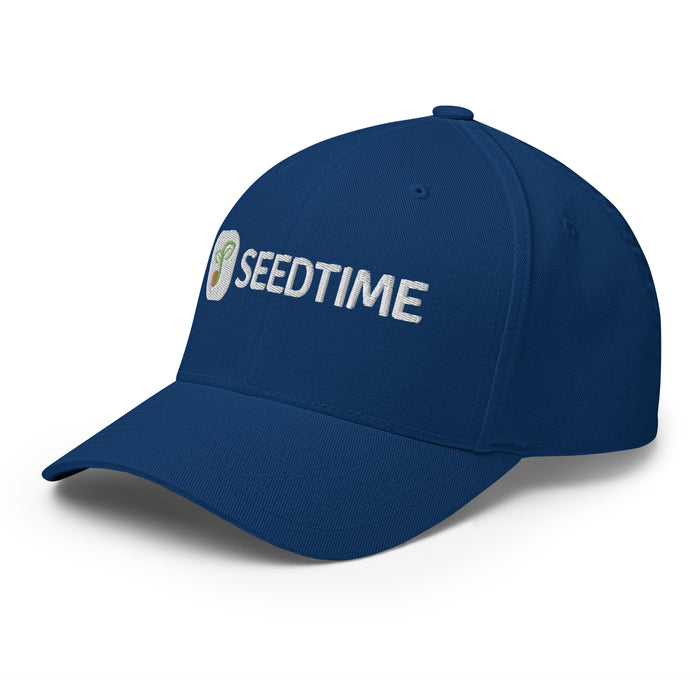Navy blue baseball cap with white embroidered "SEEDTIME" logo and green sprout design.