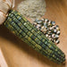 Blue corn cob, kernels, and blue cornmeal on wood. Heirloom ancient grain masa ingredients.