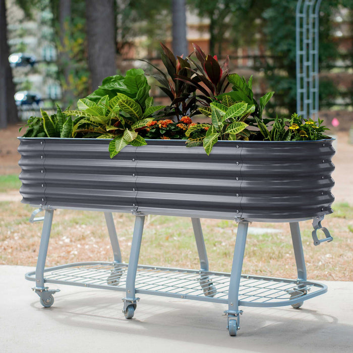 Mobile raised garden bed: dark gray corrugated metal planter with vibrant plants on a wheeled stand with shelf.