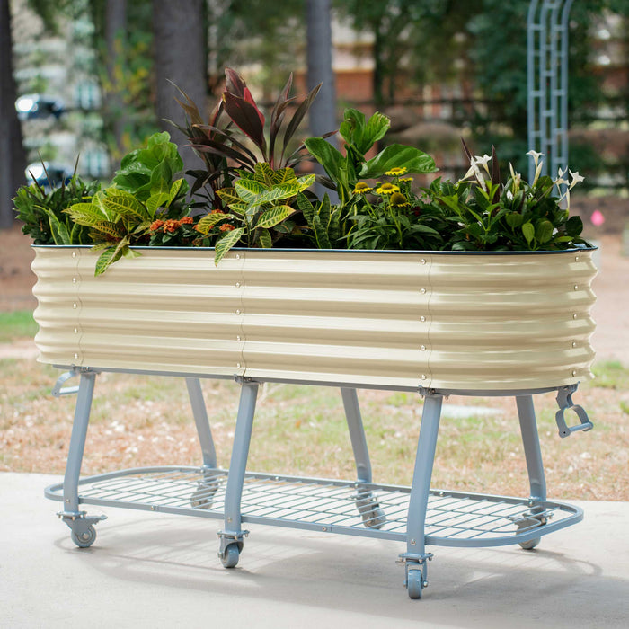 Portable beige corrugated steel raised garden bed with diverse plants and flowers on a grey wheeled stand.