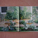 Lush raised garden beds with abundant green vegetables. Freshly harvested potatoes, tomatoes, kale, zucchini, and greens.
