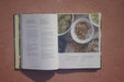 Open book: 'Growing Sprouts' & 'Growing Microgreens' guides. Bowls of fresh, vibrant sprouts and microgreens shown.