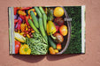 Vibrant cookbook spread: colorful fresh garden vegetables like tomatoes, peppers, cucumbers, green beans. "Fruit" section.