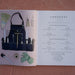 Kitchen garden book open to contents page and gardening tools: denim apron, trowel, shears, gloves, broom, measuring tape.