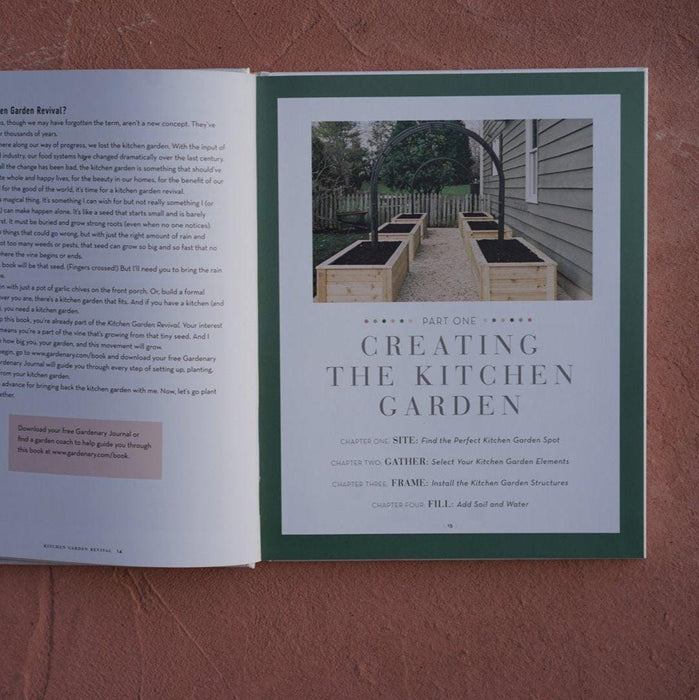 Kitchen garden design featuring wooden raised beds, fertile soil, arch trellis, and gravel path.