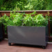 Modern dark grey mobile planter box filled with lush basil, chives, and herbs on a wooden deck.