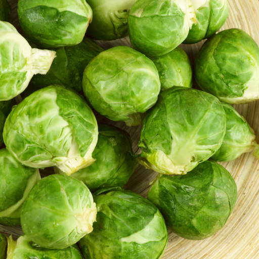 Fresh green Brussels sprouts on a light background. Healthy, raw vegetables for cooking.