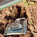 Active mole trap in garden soil by an irrigation pipe. Effective pest control solution for unwanted rodents.