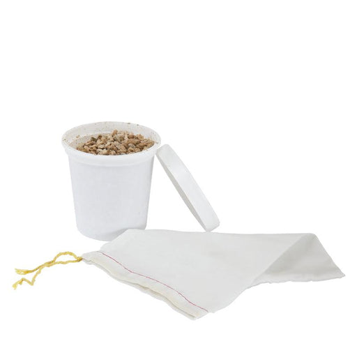 White cup with granular soil substrate, separate lid, and a white cloth drawstring bag. Gardening or lab supplies.