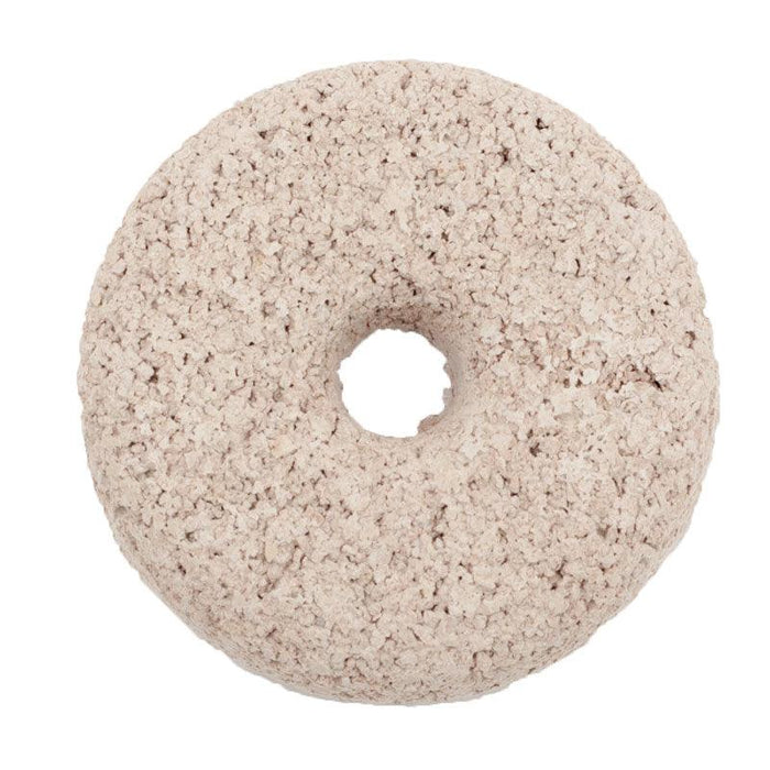 Light beige, textured donut-shaped block. Mineral lick for animals or porous filtration media.