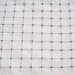 Durable black plastic garden netting with square mesh for plant support or bird protection.