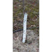 White spiral tree guard on young sapling trunk. Perforated plastic tree wrap for deer, rodent, and sun protection.