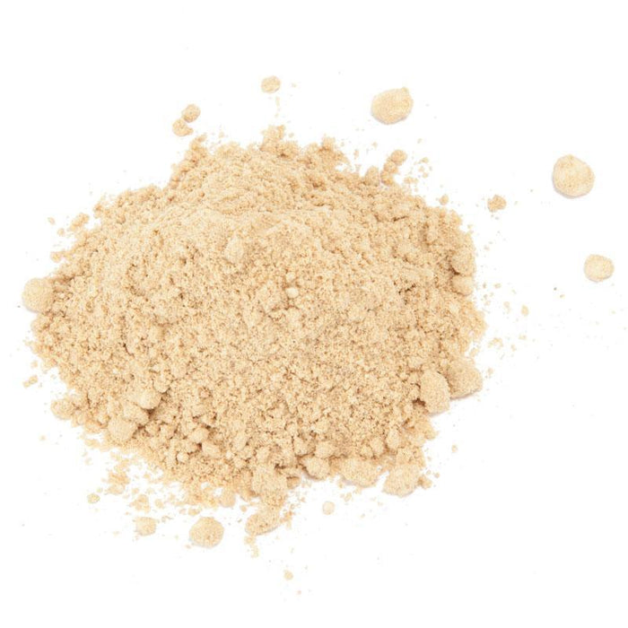 Light brown granular powder on white. Versatile cooking ingredient, spice, or supplement.