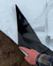 Hand lifting white agricultural mulch film, revealing black layer on garden soil.