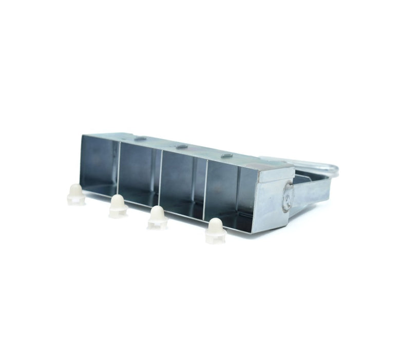 Metal 5-cell seedling tray with four white plastic plugs for garden seed starting.