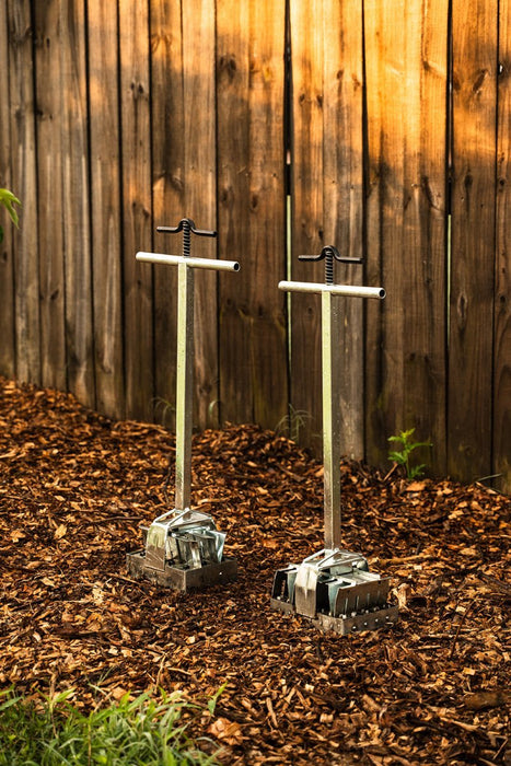 Two metal soil block makers on wood chip mulch. Essential garden tools for seed starting and plant propagation.