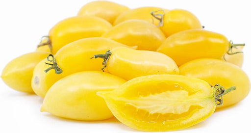 A pile of fresh, bright yellow plum tomatoes, with one cut open to reveal its juicy yellow interior.