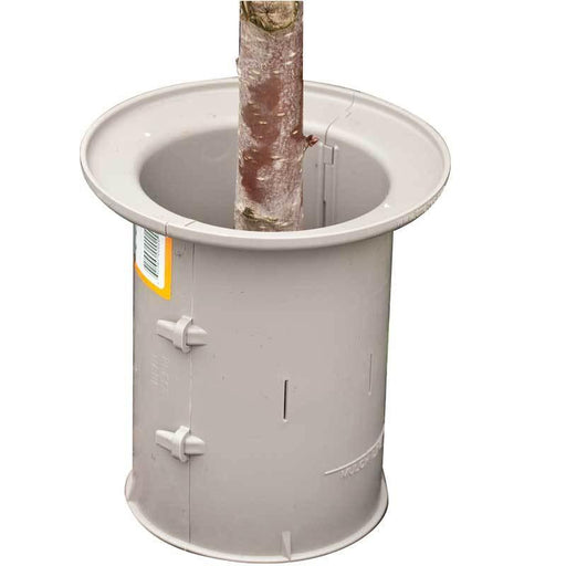 Gray tree protector and watering ring for young trees. Mulch guard for sapling root protection and plant care.