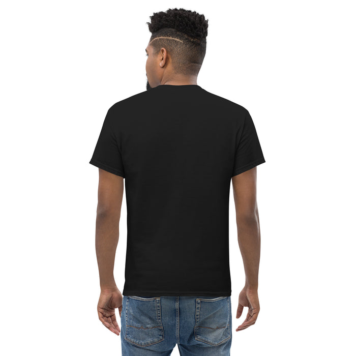 Man wearing plain black t-shirt and blue jeans, back view. Blank men's tee for custom designs or casual wear.