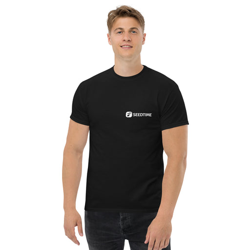 Smiling man in black Seedtime logo t-shirt. Men's casual apparel, branded tee shirt.