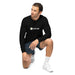 Man kneeling in black SEEDTIME long-sleeve shirt, dark shorts, and white sneakers. Casual athletic apparel.