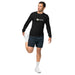 Man in black Seedtime long-sleeve shirt & dark shorts stretching quad. Activewear, fitness, workout gear.