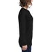 Woman wearing black long sleeve crew neck t-shirt and jeans, side view.