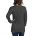 Dark gray heather long-sleeve t-shirt on a woman, back view. Casual charcoal top, blue jeans. Blank apparel mockup.