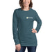 Smiling woman wearing a heather teal long-sleeve t-shirt with white Seedtime logo and green sprout.