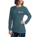 Smiling woman in a dark teal Seedtime long-sleeve t-shirt. Casual women's gardening apparel.