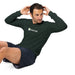 Man doing sit-ups in dark green Seedtime long-sleeve shirt and shorts. Fitness, workout, activewear.