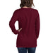 Women's maroon long sleeve t-shirt, back view. Casual burgundy crewneck tee with hand on hip, wearing jeans.