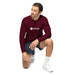 Maroon Seedtime long-sleeve shirt on man in dark shorts, white sneakers, kneeling. Casual men's activewear, white background.