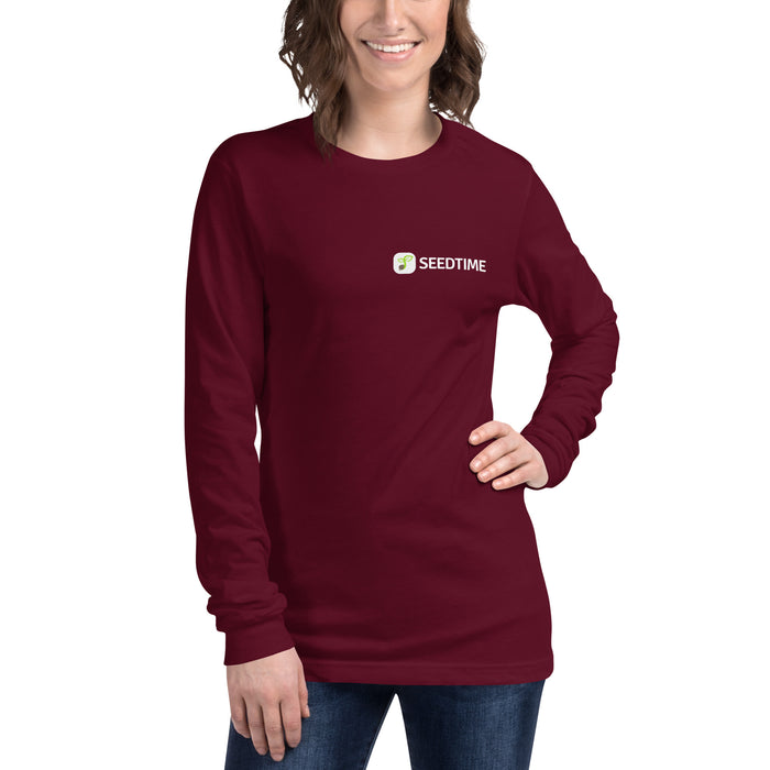 Woman in maroon long-sleeve t-shirt with Seedtime logo. Comfortable women's burgundy long sleeve tee.