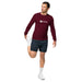 Athlete in maroon SEEDTIME long-sleeve shirt & black shorts performing quad stretch. Active fitness apparel.