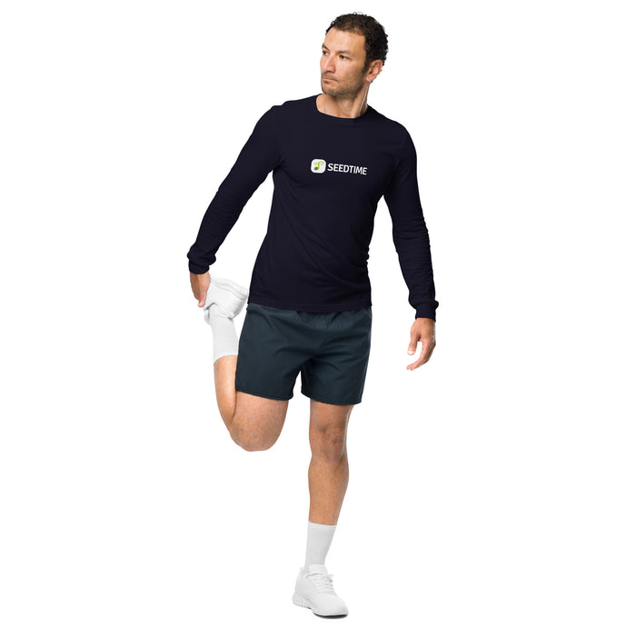 Man in navy Seedtime long-sleeve shirt and dark shorts stretching his quadricep. Athletic wear, fitness, activewear.