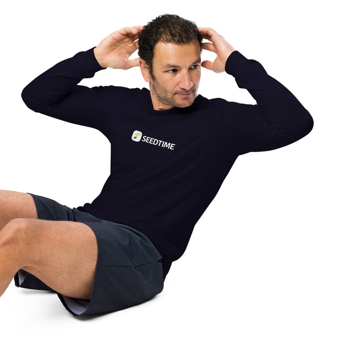 Man doing sit-ups wearing navy Seedtime long-sleeve athletic shirt & grey shorts. Fitness, workout gear.
