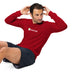 Man in red Seedtime long-sleeve fitness shirt & dark shorts doing a sit-up workout.