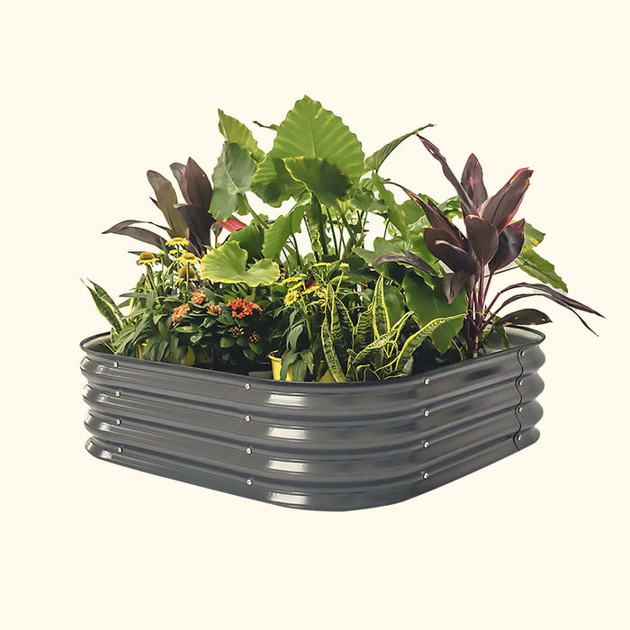 Dark gray corrugated metal raised garden bed filled with lush green plants, vibrant yellow flowers, and deep red foliage.
