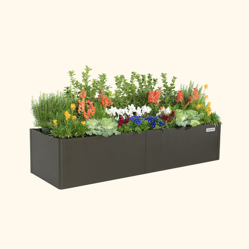 Vego Garden dark metal raised garden bed planter filled with colorful flowers, green herbs, and ornamental kale.