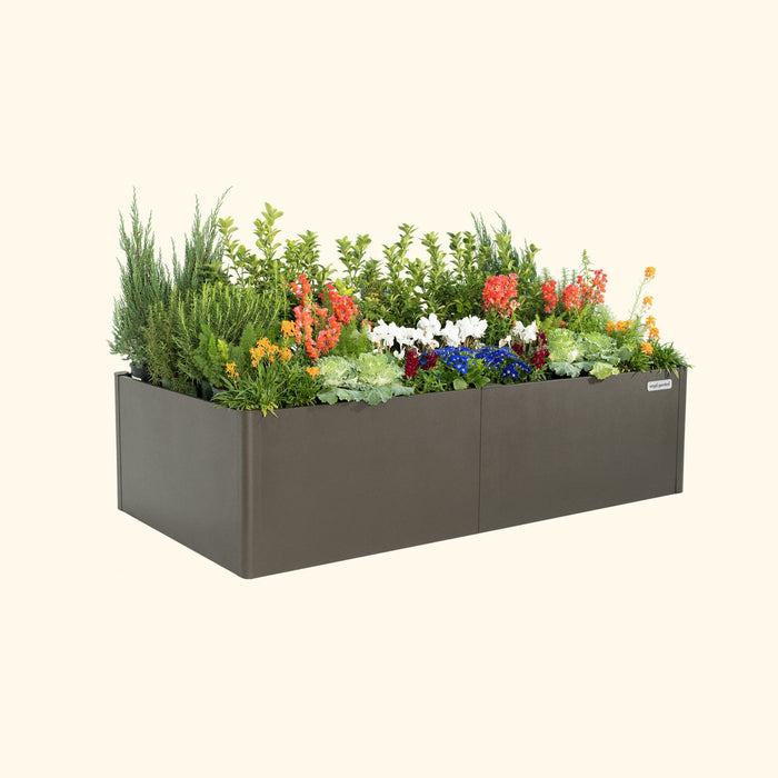 Dark gray Vego Garden metal raised bed with colorful orange, white, blue, red flowers and green foliage.